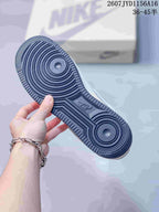 Close view of the dark rubber outsole with concentric circular traction patterns and geometric grooves.