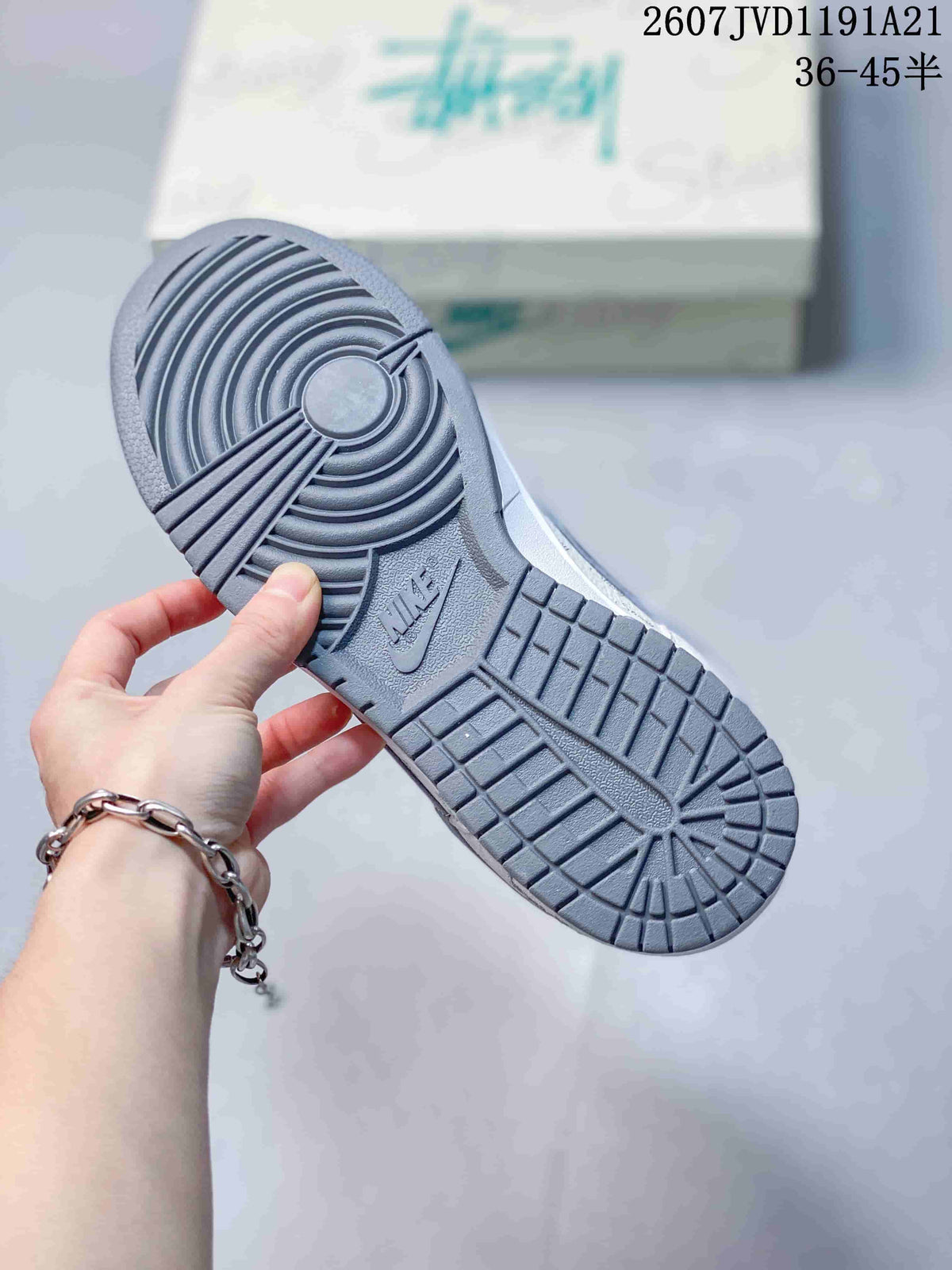 Close-up of the gray rubber outsole showing concentric circular traction at the forefoot and patterned tread under the heel.