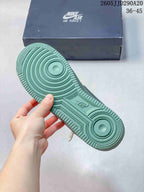 Close view of the green outsole showing concentric circular traction details and molded branding.