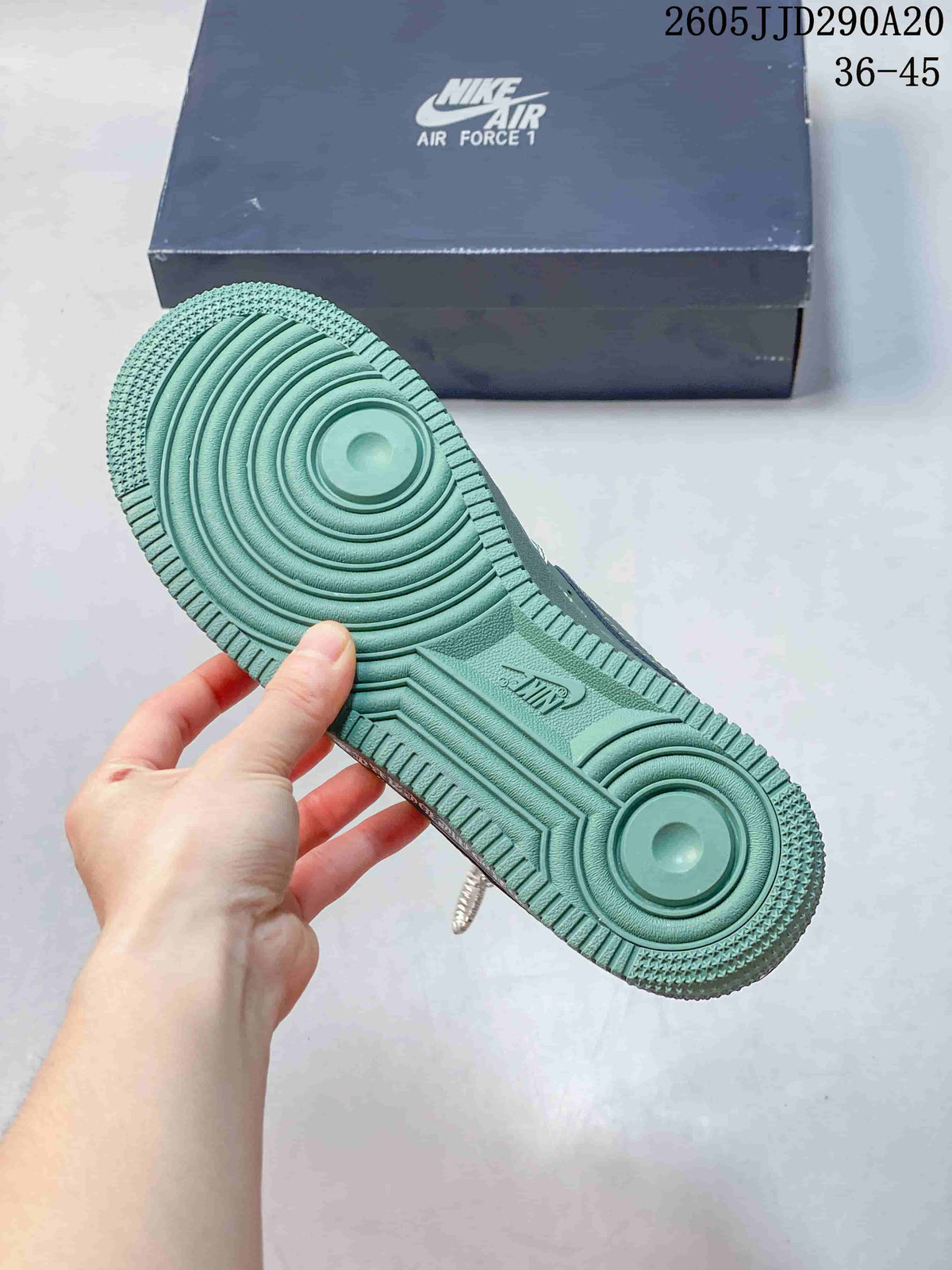 Close view of the green outsole showing concentric circular traction details and molded branding.