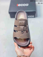 Top view of the brown open-toe sandal showing the patterned footbed, strap layout, and front fastener.