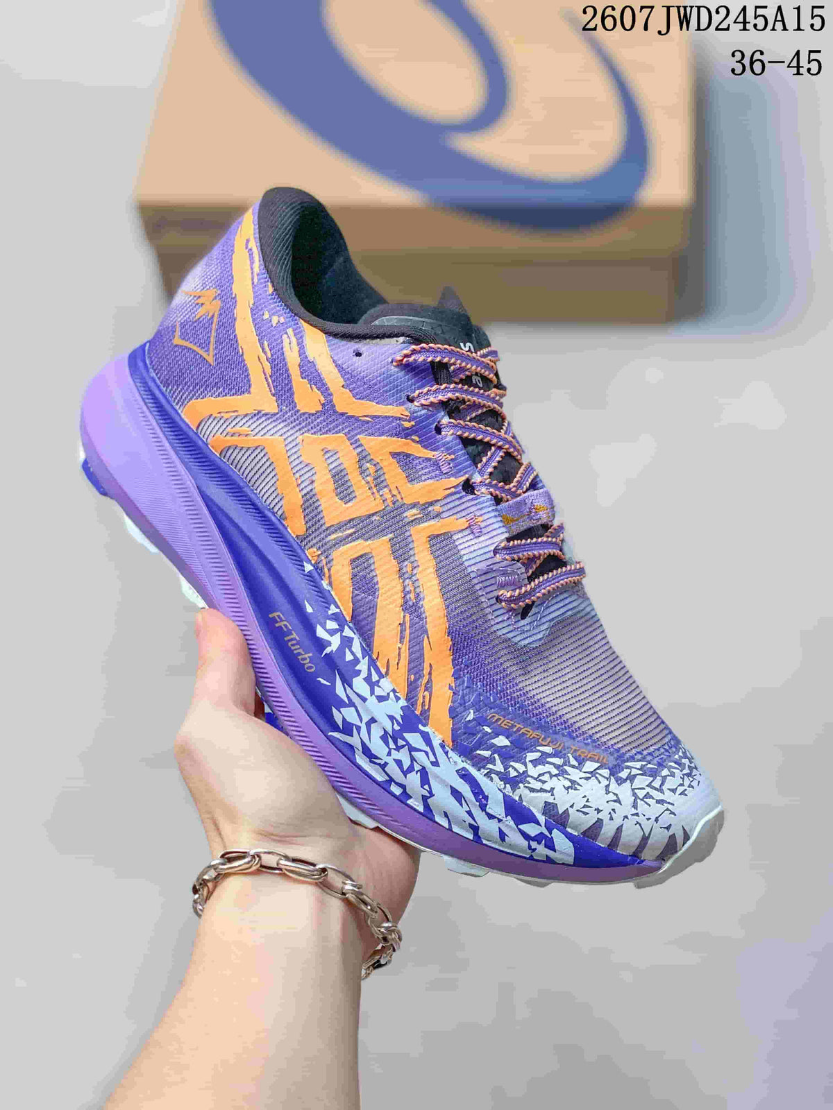Close-up of a purple and orange ASICS sneaker with patterned upper, purple midsole and contrasting laces.