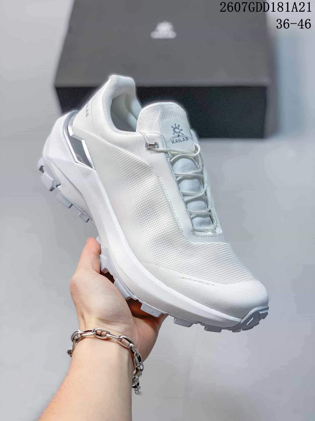 Angled side view of the white KAILAS VENTO shoe showing the upper, lace toggle and rugged outsole.