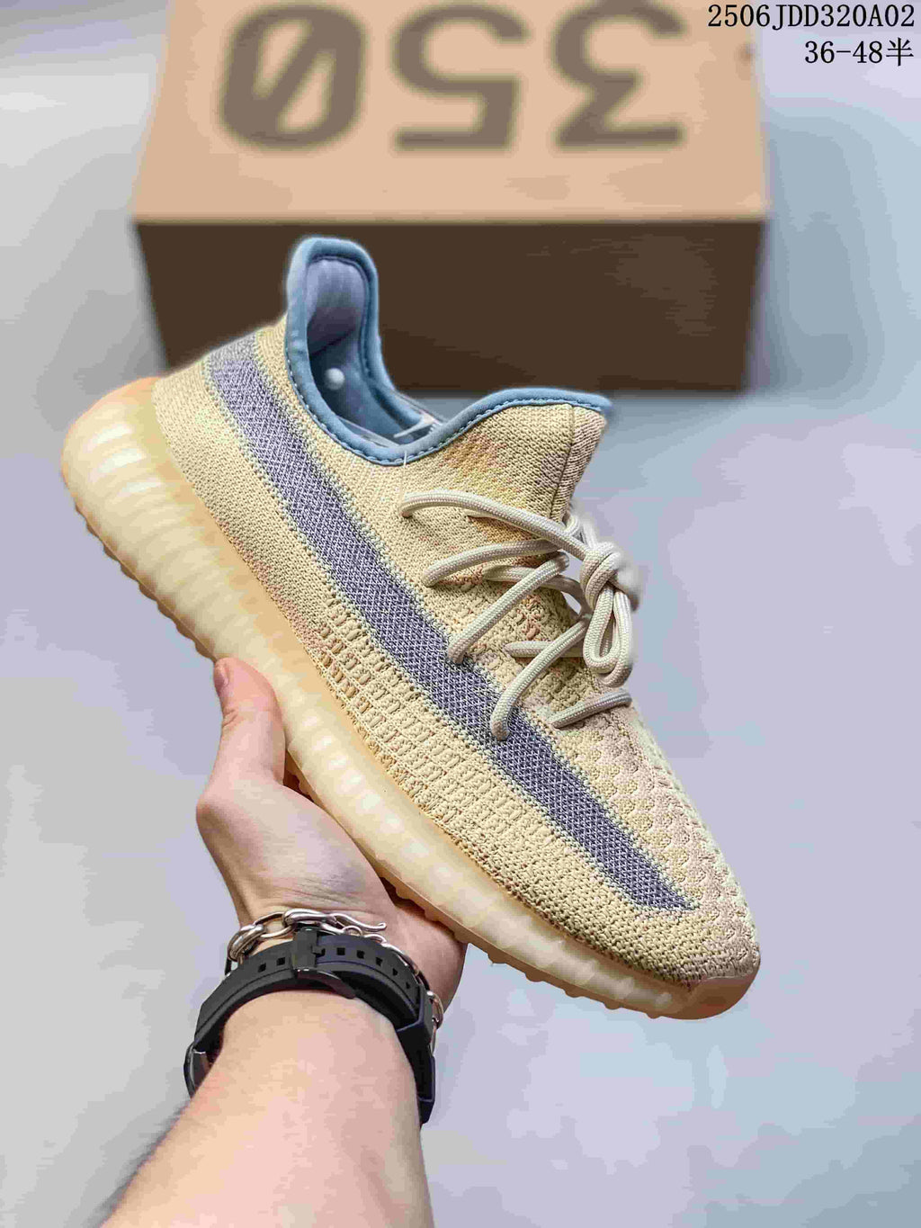 Cream Adidas Yeezy-style sneaker with a gray side stripe and pale ridged sole.