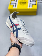 Angled side view highlighting the white upper, blue and red stripes, low-top collar, and patterned outsole.