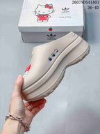 Side view of the beige mule clog showing its raised sole and ventilation holes