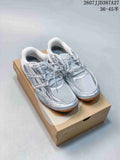 Pair of silver ASICS Hypersync low-top sneakers displayed on an ASICS shoe box.