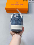 Rear view of the sneaker showing a navy heel panel and white midsole.