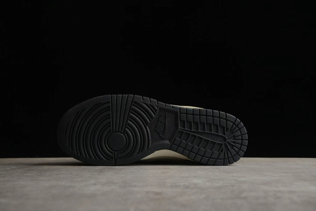 Bottom view showing the black rubber outsole with circular and block-pattern traction.