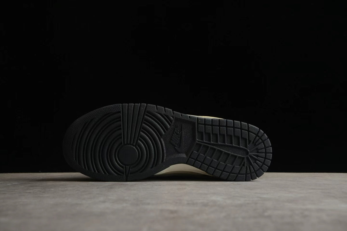 Bottom view showing the black rubber outsole with circular and block-pattern traction.