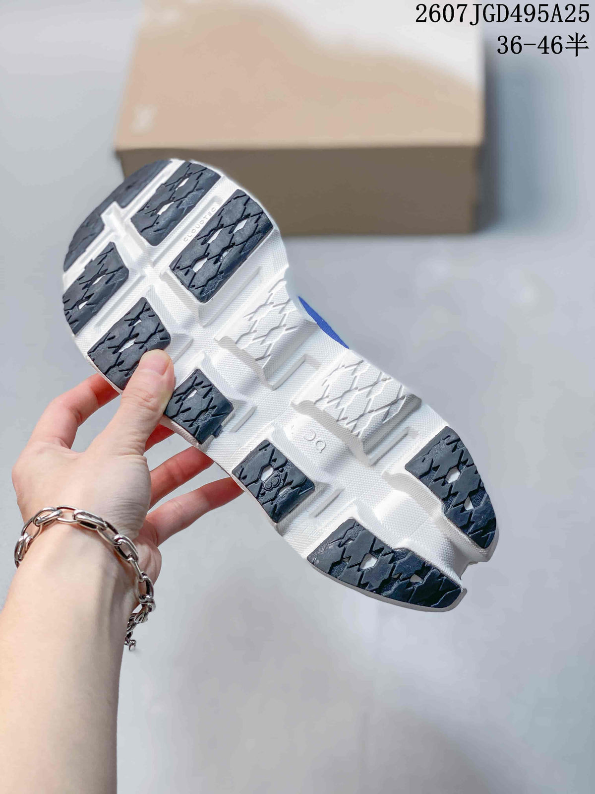 Underside view showing the white sole, open channels and dark rubber traction sections