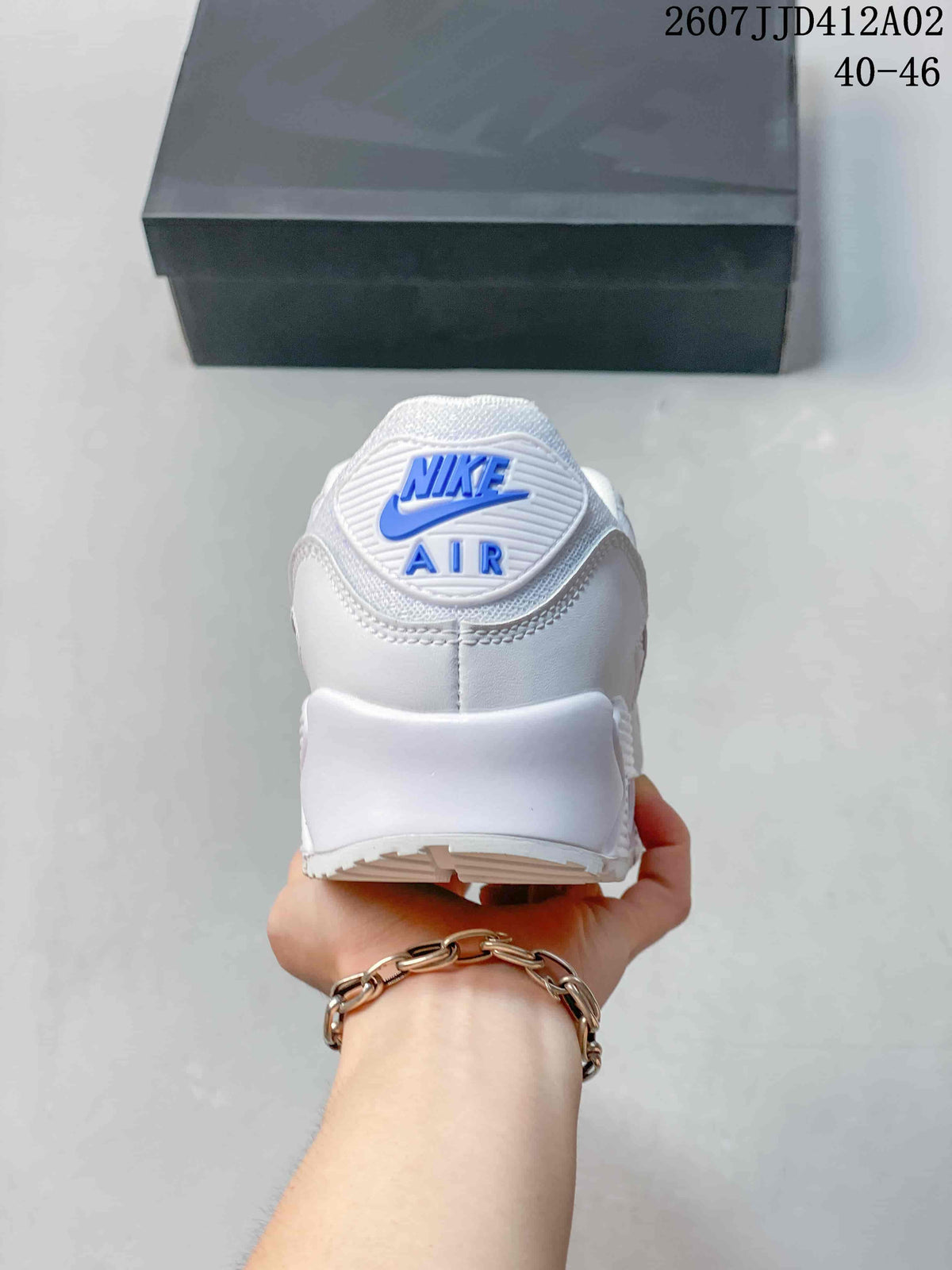 Rear view of a white sneaker with blue Nike Air branding
