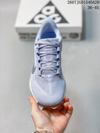 Top view of the sneaker showing the rounded toe, textured upper, tongue, laces, and gray Swoosh detail.