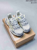 Pair of silver, white, and lime ASICS GEL-KAYANO 14 sneakers displayed on a shoebox.