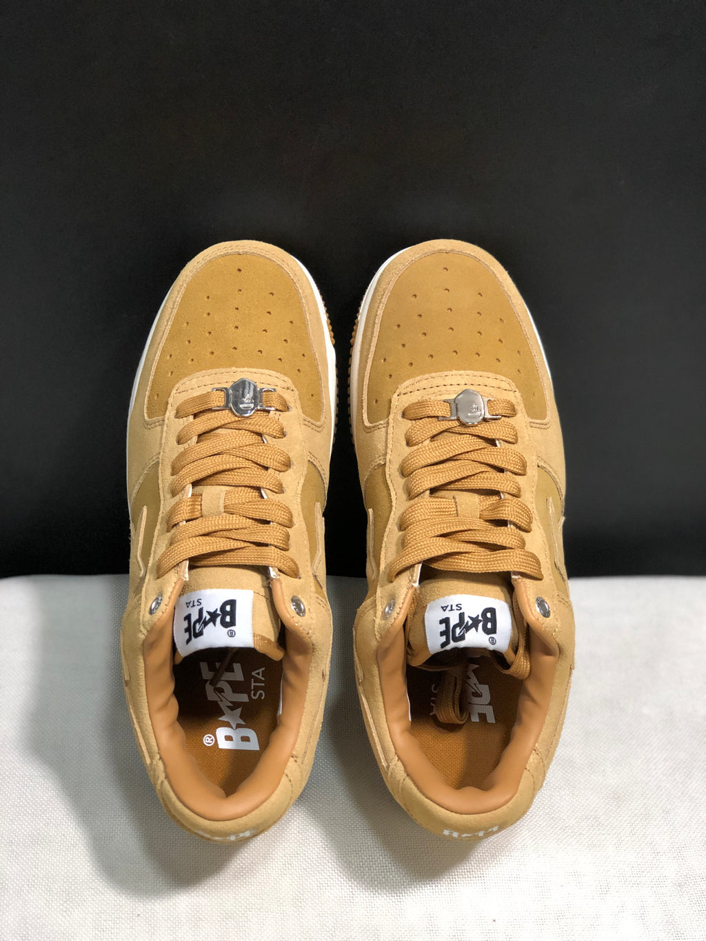 Top-down view showing the perforated toe boxes, matching laces, silver-tone lace hardware and branded insoles.
