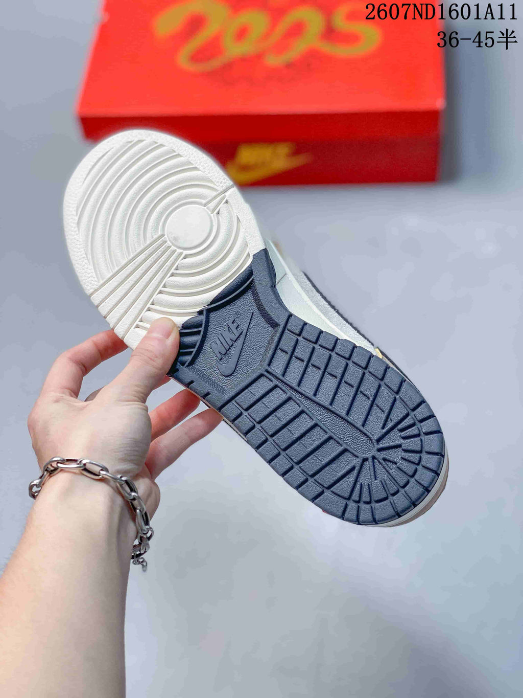 Underside view showing the navy and white rubber outsole with circular traction patterns and embossed Nike branding.