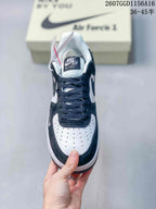 Top view of one sneaker showing the black laces, white perforated toe box, dark overlays, and tongue branding.