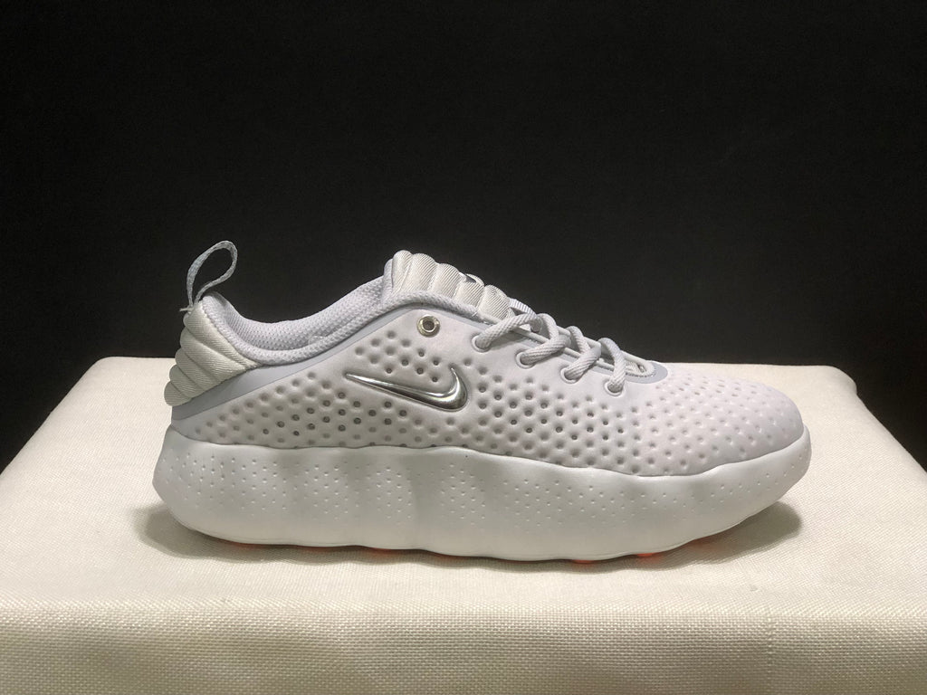 Single white sneaker in side profile, showing the textured upper, side logo and sculpted white midsole.