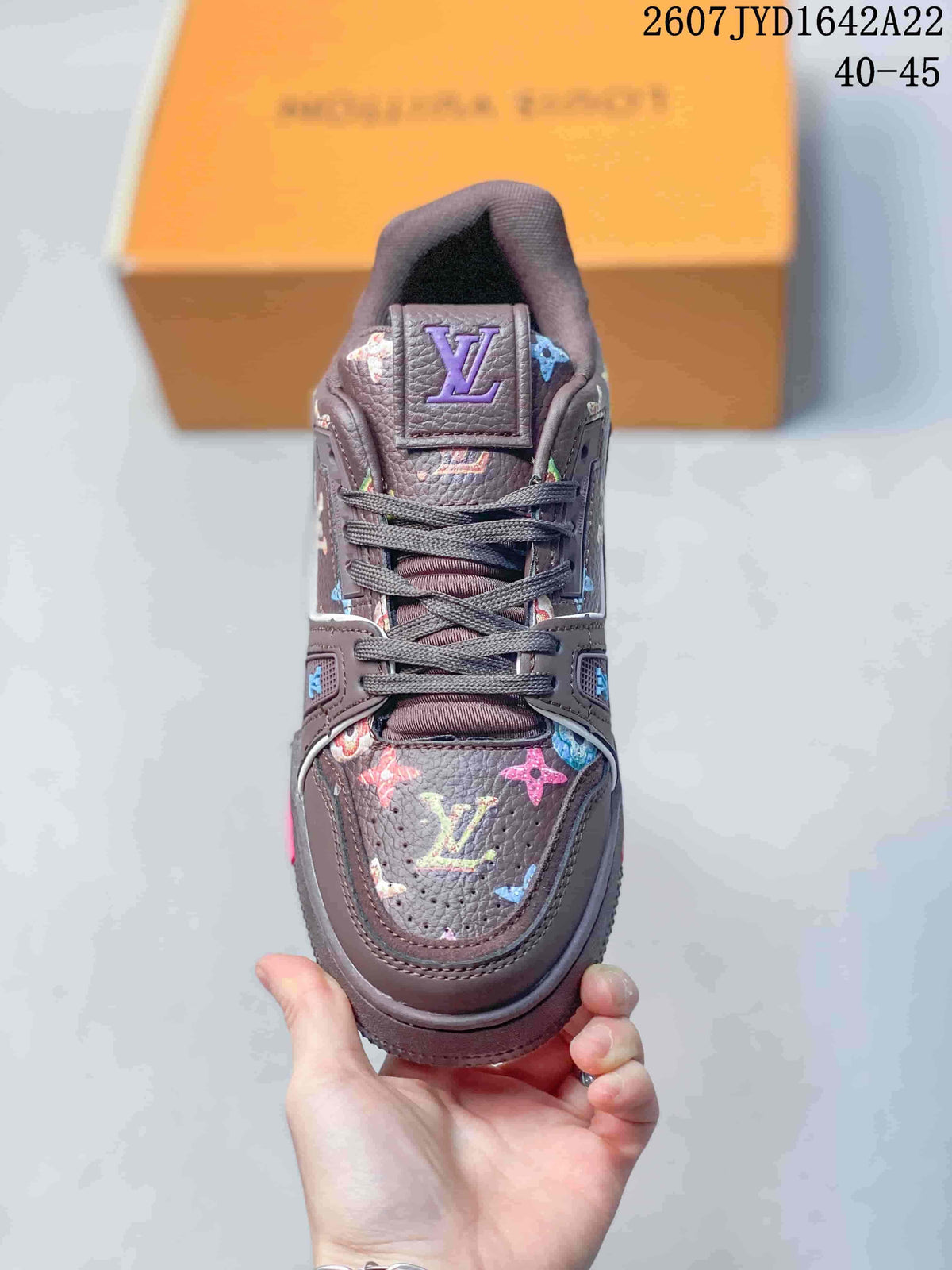 Top view of the dark brown sneaker showing the lace-up front, padded tongue, and multicolor motifs; image text shows 2607 TYD1642A22 and 40–45.