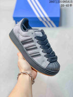 Angled side view highlighting the shell toe, black side stripes and layered sole.