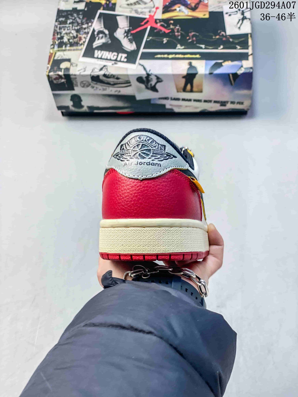Rear view showing the red heel, light-colored midsole, and red outsole.