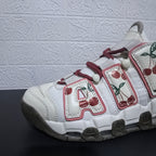 Close-up of the sneaker upper, burgundy laces, and cherry print