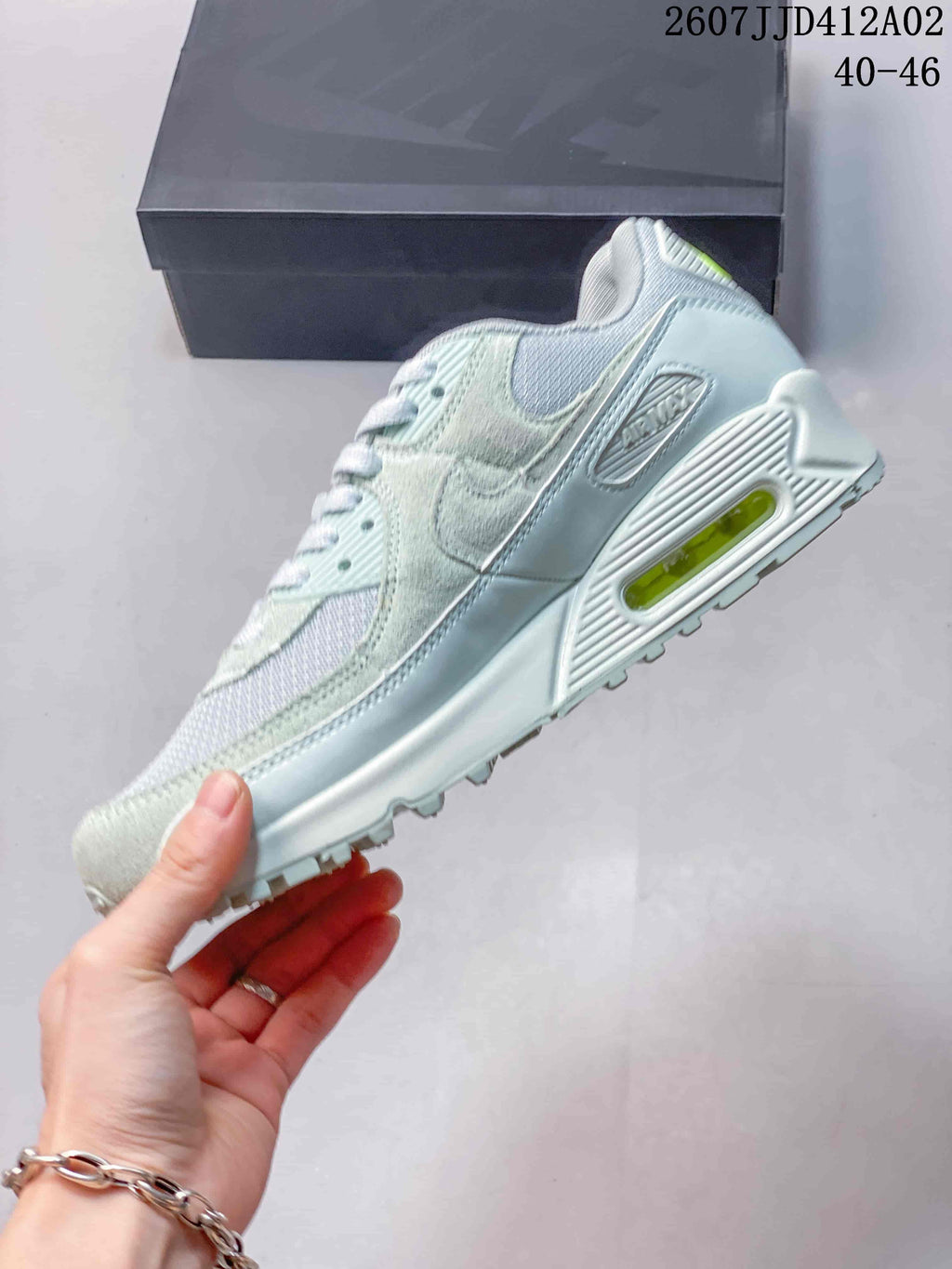 Side view of the Nike Air Max 90 sneaker showing its layered panels and visible heel Air unit.