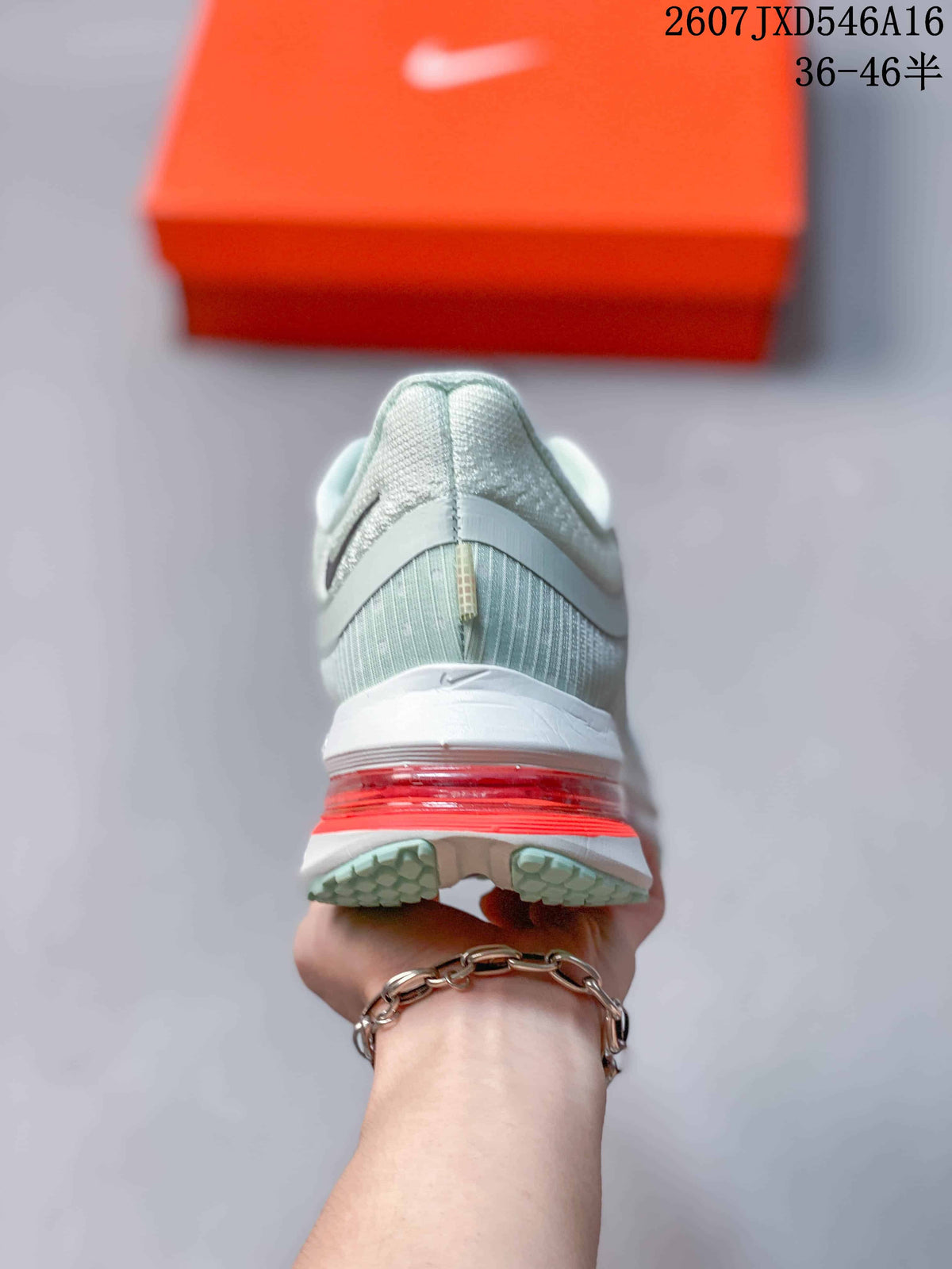 Rear view showing the padded heel, mint-toned upper, white midsole, and red visible cushioning.