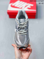 Front view of the silver and grey lace-up sneaker with mesh toe and tongue panels.
