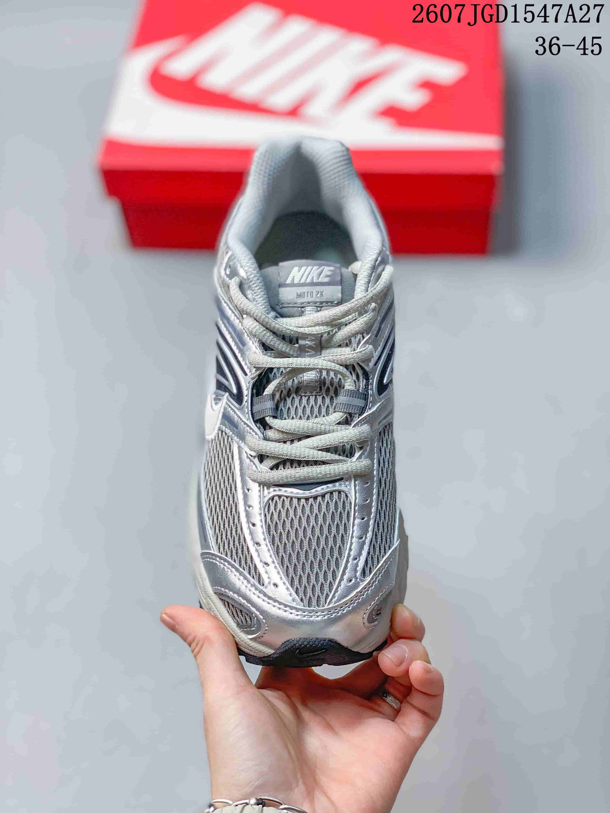 Front view of the silver and grey lace-up sneaker with mesh toe and tongue panels.