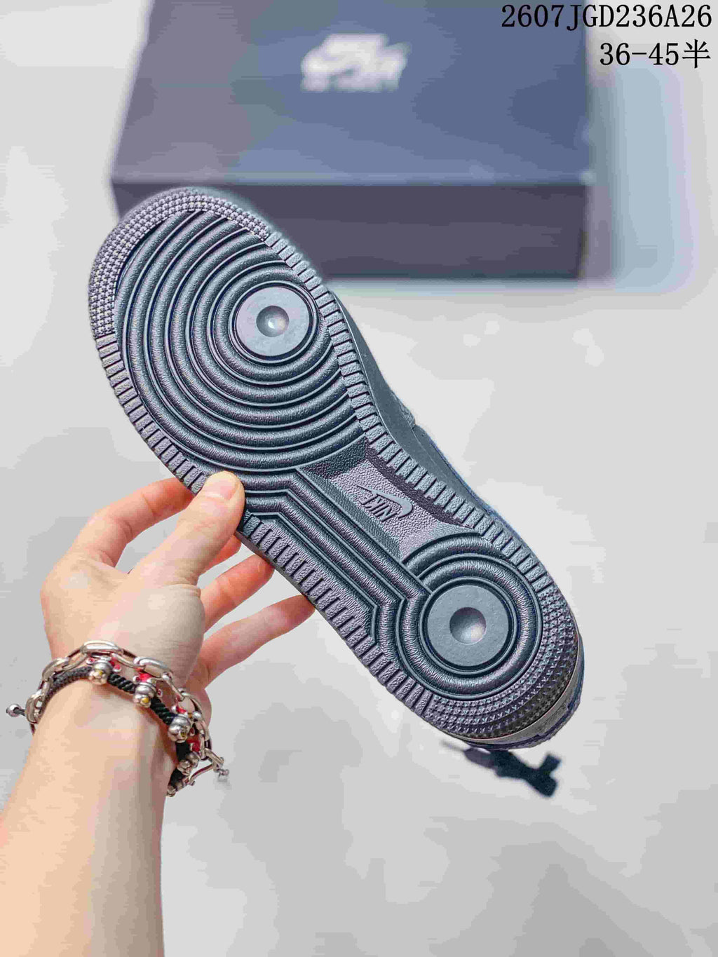 Close view of the dark textured rubber outsole with concentric circular traction zones.