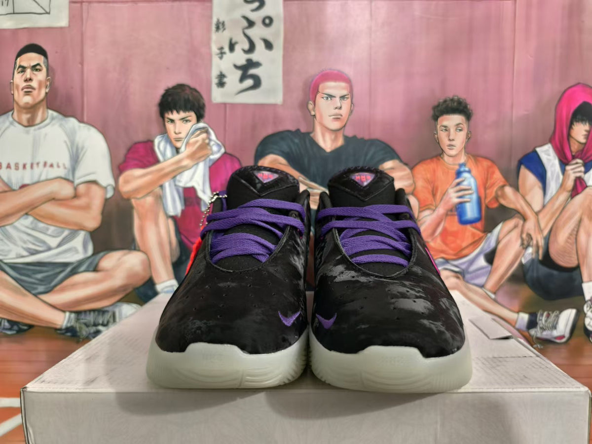 Front view of black basketball shoes with purple laces, pink accents, and light-colored outsoles