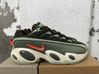 Side view showing a patterned panel, orange Nike swoosh, and sculpted cream-colored sole.