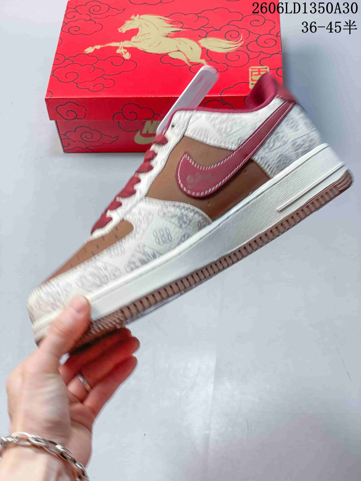 Side view of the low-top sneaker with brown and cream panels and a red Swoosh