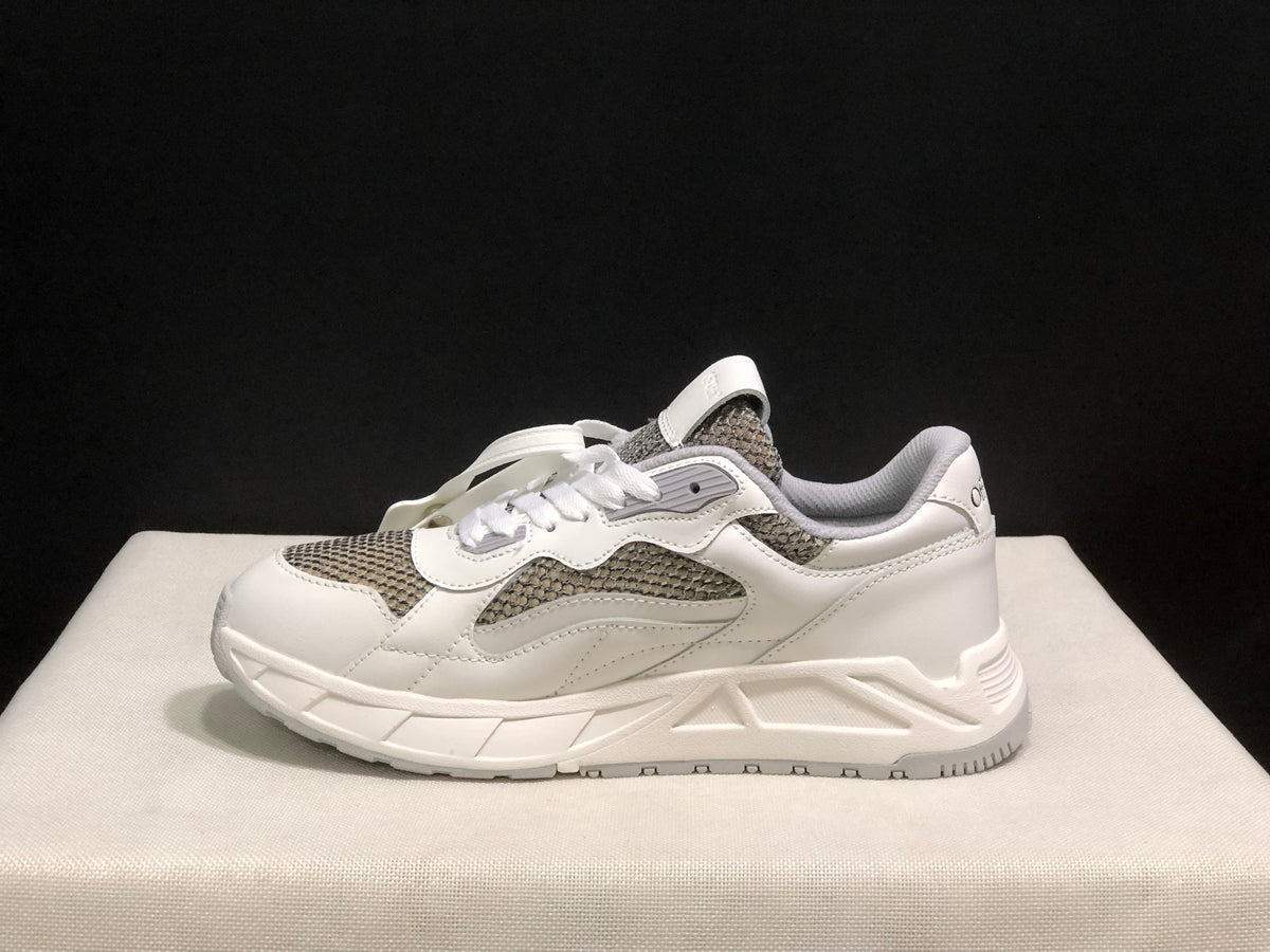 Outer side profile showing the low-top shape, panel stitching and sculpted outsole.