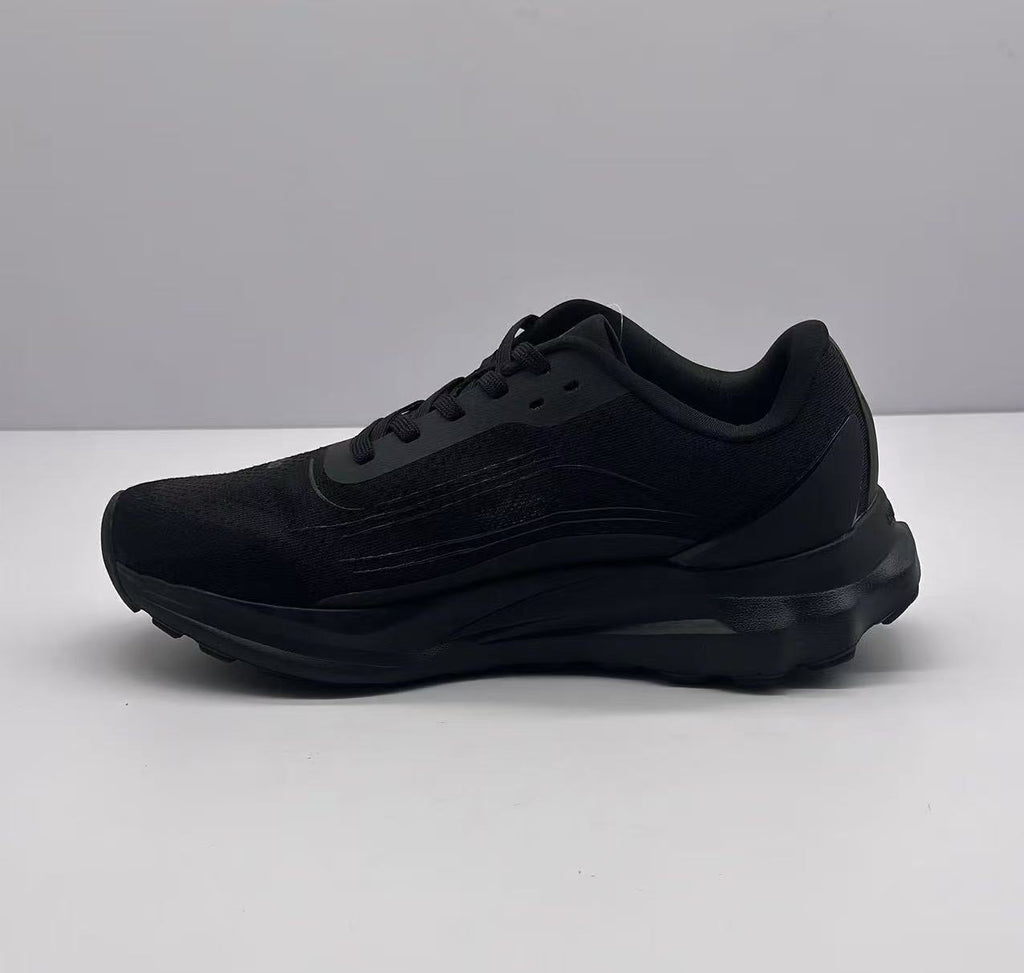 Opposite side profile of the all-black Alo sneaker with tonal side detailing and a textured black sole.