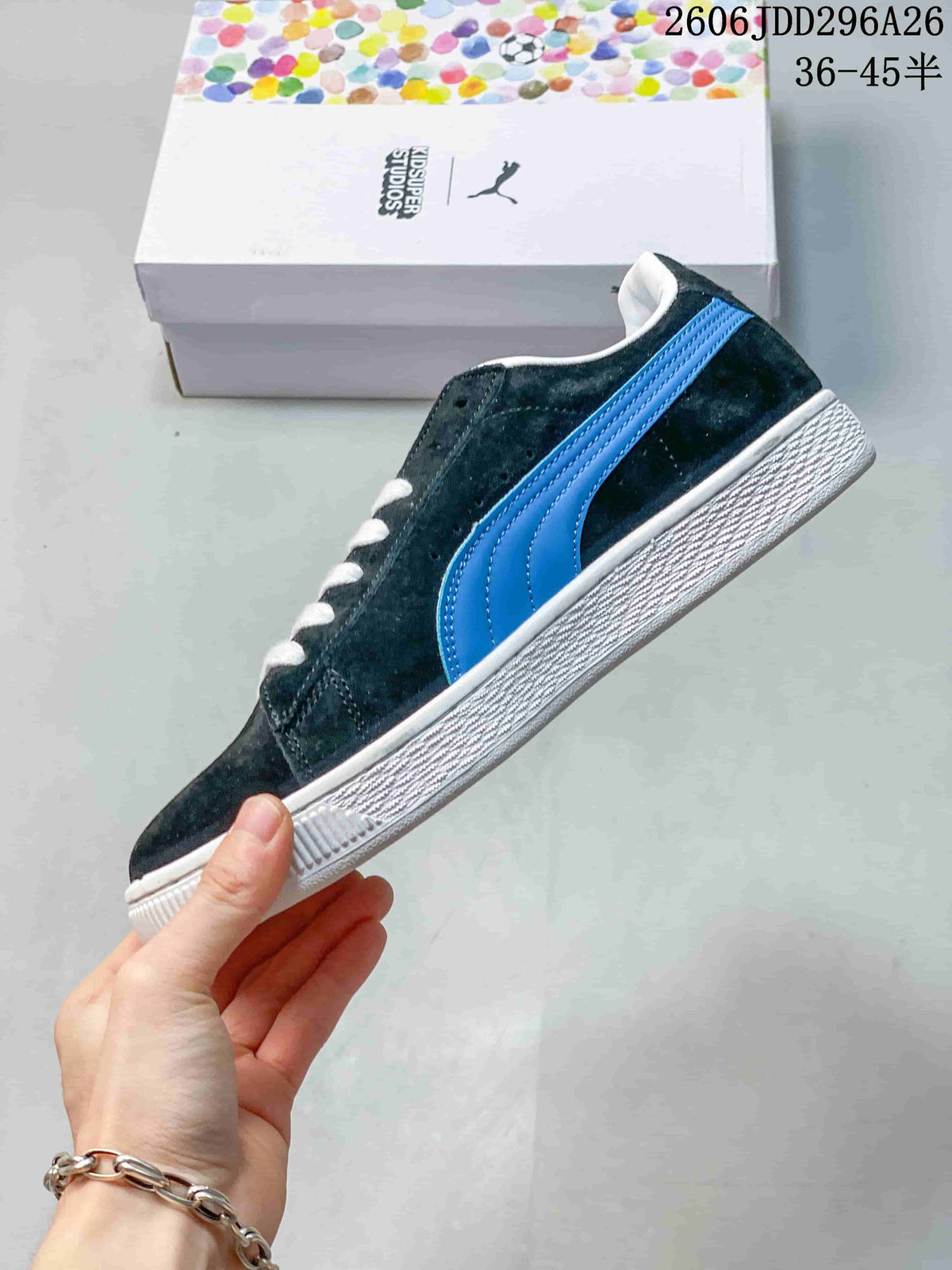Side profile of a dark blue low-top sneaker with a bright blue PUMA side stripe and textured white midsole.