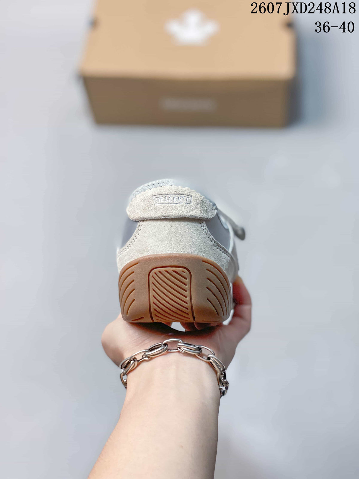 Rear view of the sneaker showing the heel overlay and gum-colored outsole.