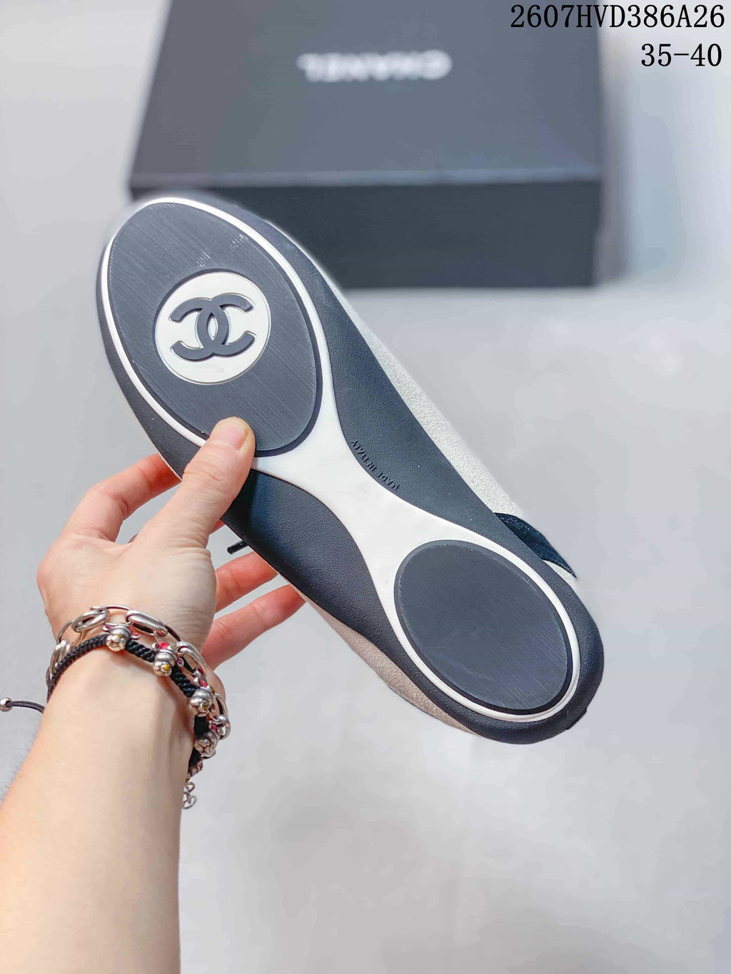 Outsole view of a Chanel sneaker showing the black-and-white tread layout and Chanel logo detail.