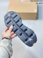 Close view of the sneaker outsole showing segmented traction panels and open channel details.