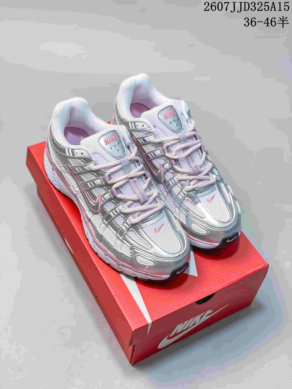 Pair of silver and pink Nike sneakers displayed on a red Nike shoebox; image text shows style code 2607JJD325A15 and size range 36–46.5.