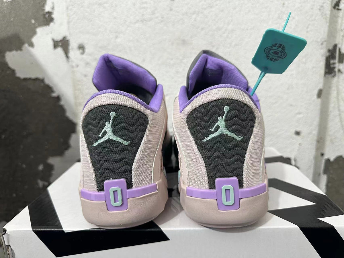 Rear view of pale pink basketball shoes with purple collars, dark heel panels, and mint-colored Jumpman-style marks.