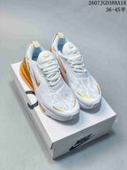 Pair of white and gold Nike Air Max 270 sneakers displayed on a Nike shoe box.