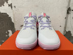 Front view of white Nike basketball shoes with lavender laces and pink outsoles