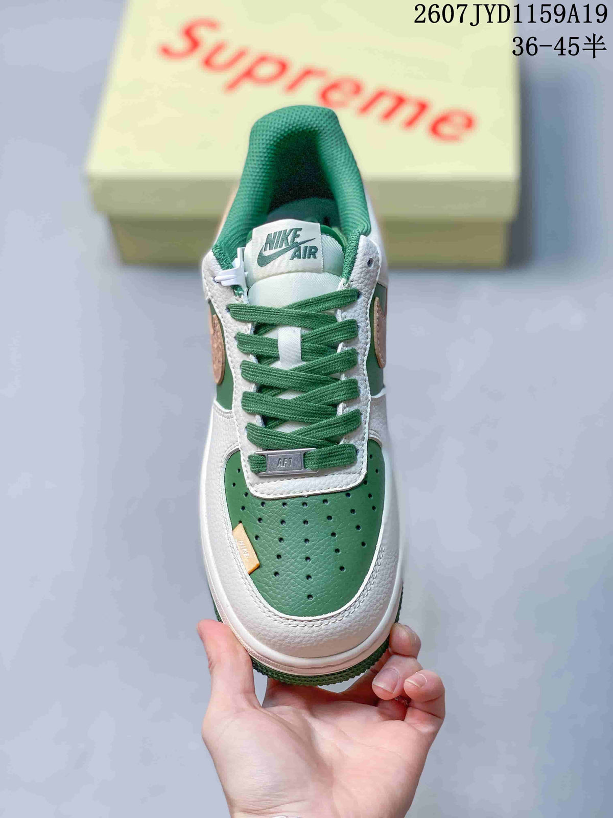 Top view showing the perforated green toe box, green laces, white tongue and Nike Air label.