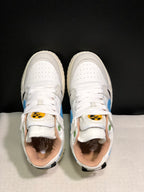 Top view showing white laces, perforated toe panels, colored tongue labels, and contrasting interior details.