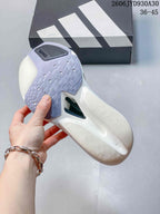 Close-up of the outsole on a white adidas Adizero Prime X3 shoe.