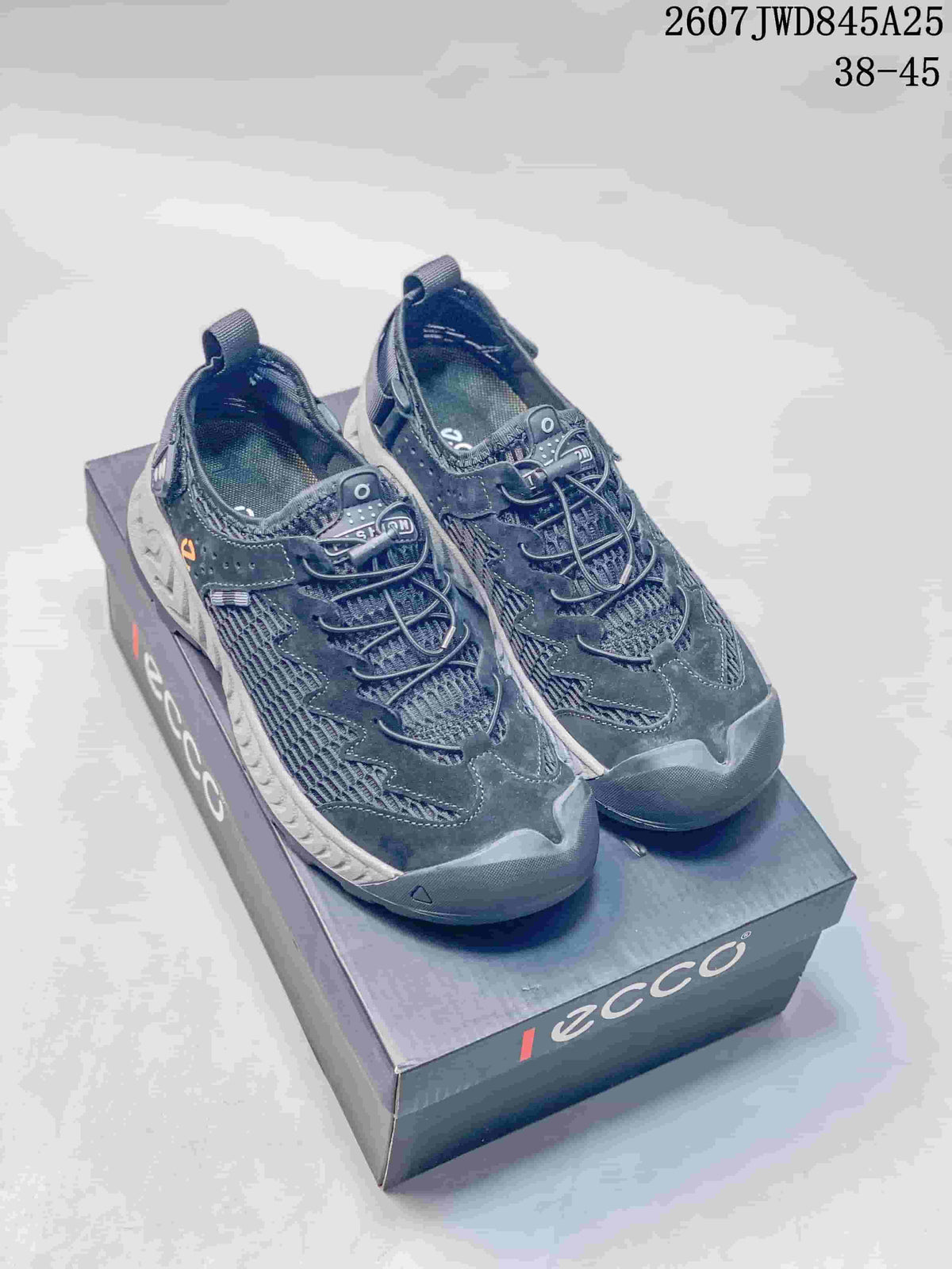 Pair of dark navy and black ECCO mesh sneakers displayed on an ECCO shoebox; style code 2607JWD845A25 and size range 38–45 are visible.