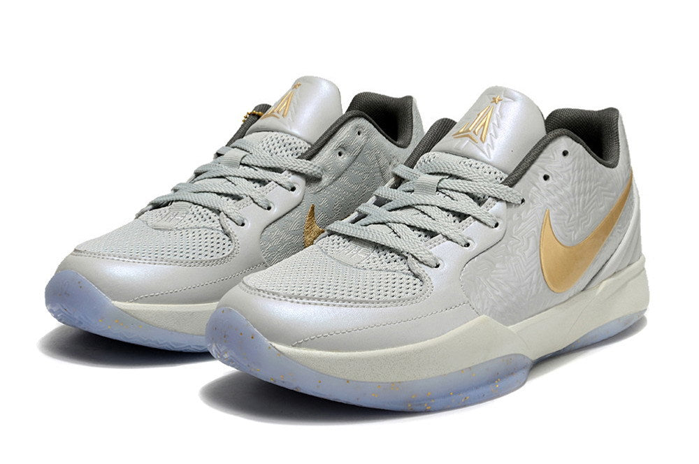 Pair of gray and gold Ja 2 basketball shoes in a front three-quarter view.