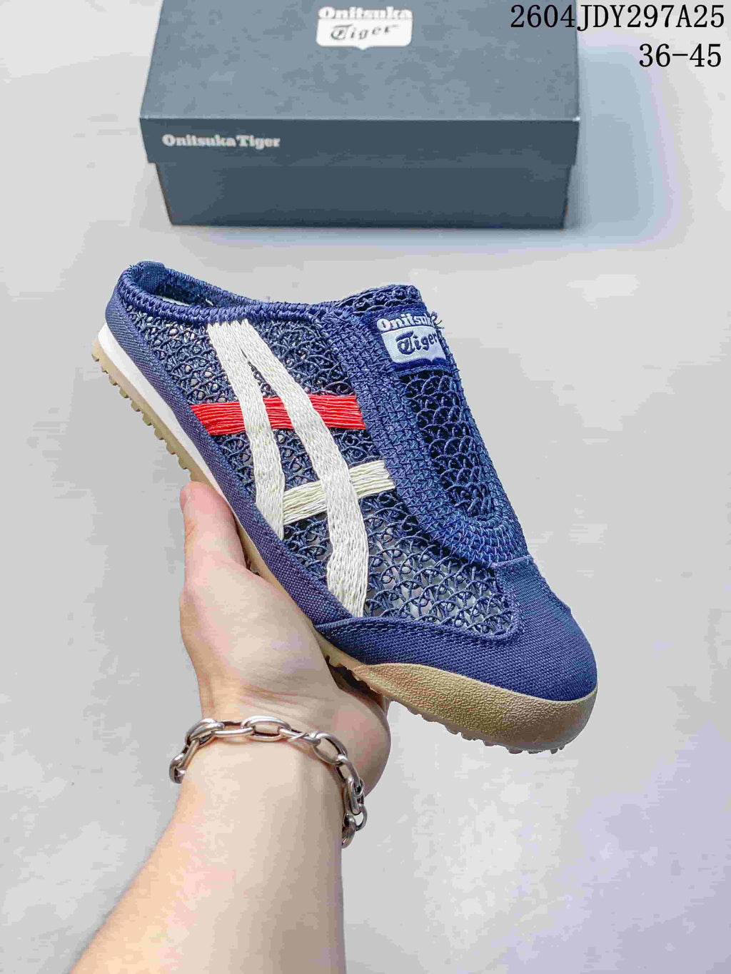 Dark blue Onitsuka Tiger Mexico 66 Sabot slip-on sneaker with white, red and cream contrasting stripes.